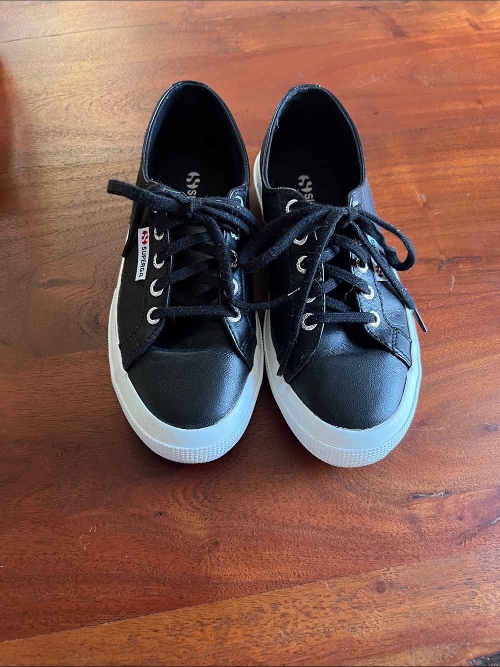 Superga black leather sneakers.